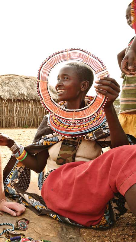 maasai woman talking to visitor at village with ol lentille trust