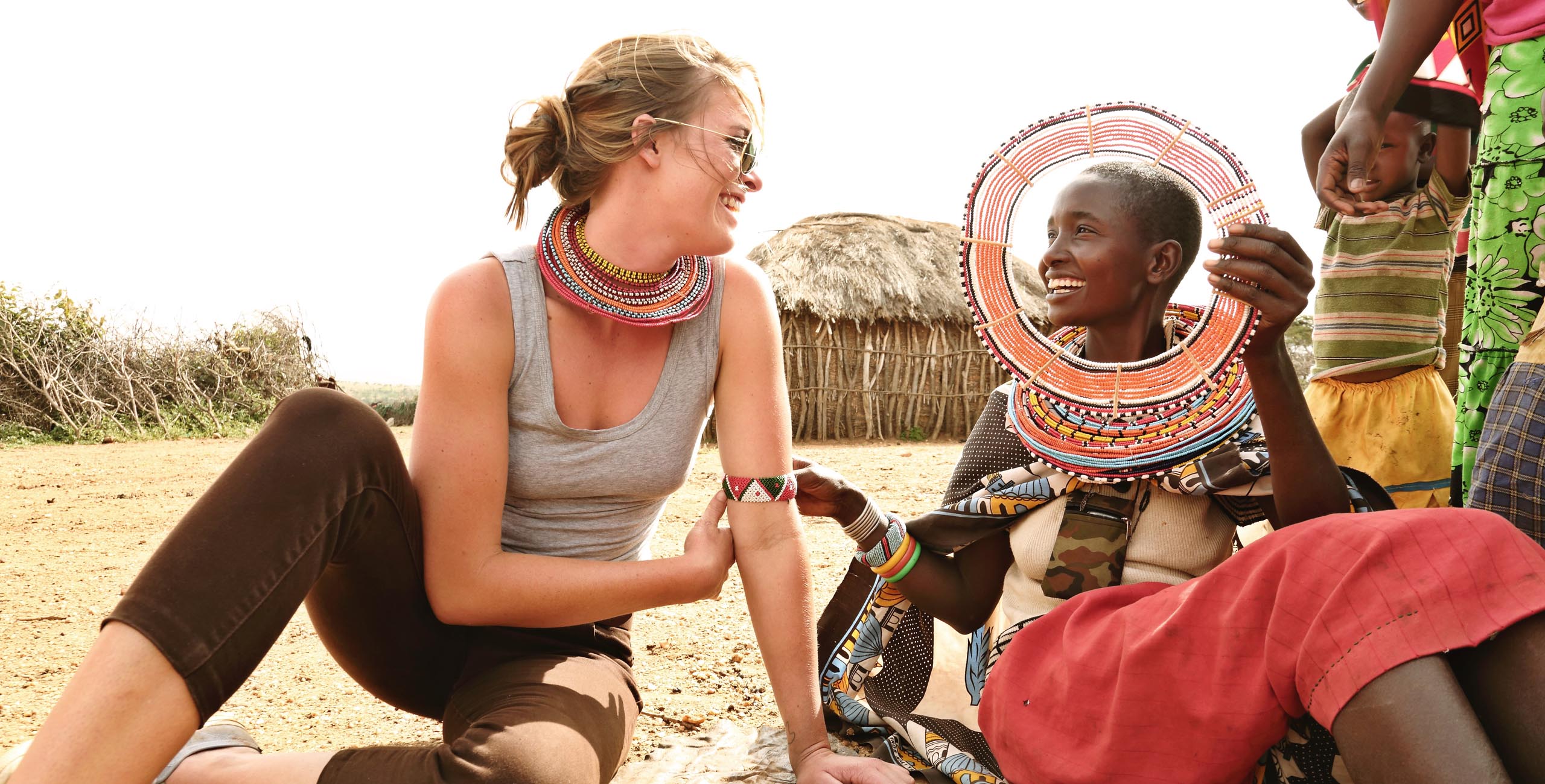 maasai woman talking to visitor at village with ol lentille trust