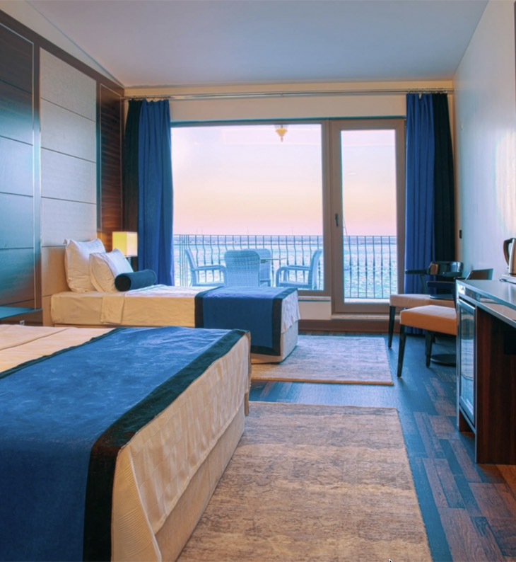 view of a bedroom suite at north door hotel in amasra with sea on horizon